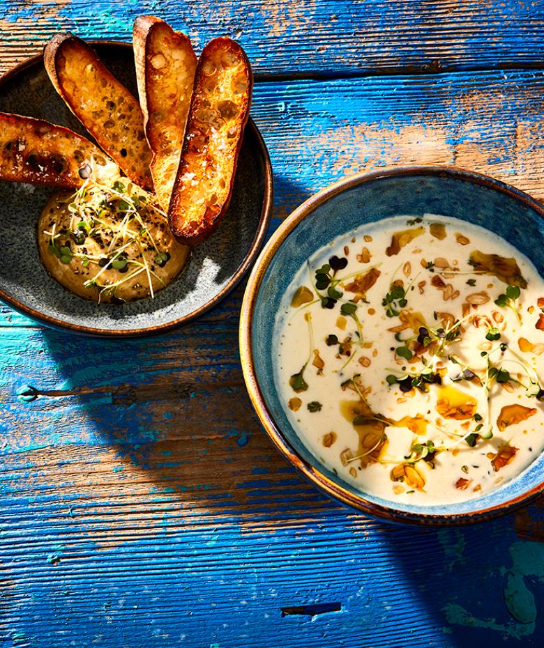 Mobile header Potato-onion soup with porcini mushroom sauce and crostini.